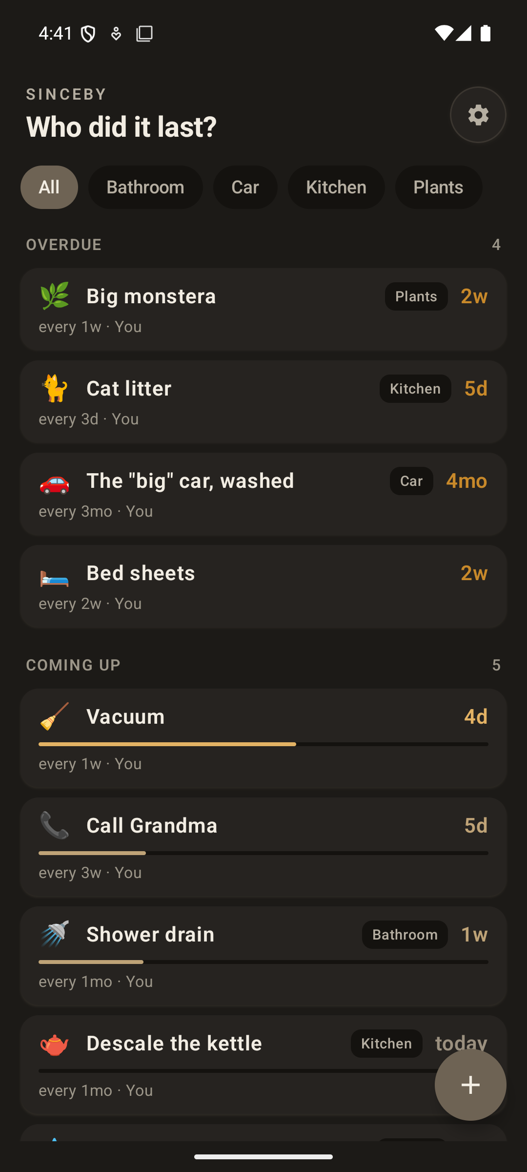 The same home list in dark mode: a warm near-black background with cream text, the same gold elapsed times, and the same Overdue and Coming up sections.